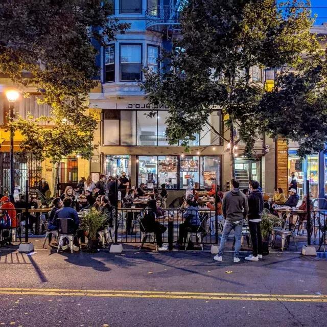 A crowd enjoys food and drink along San Francisco's Valencia Street