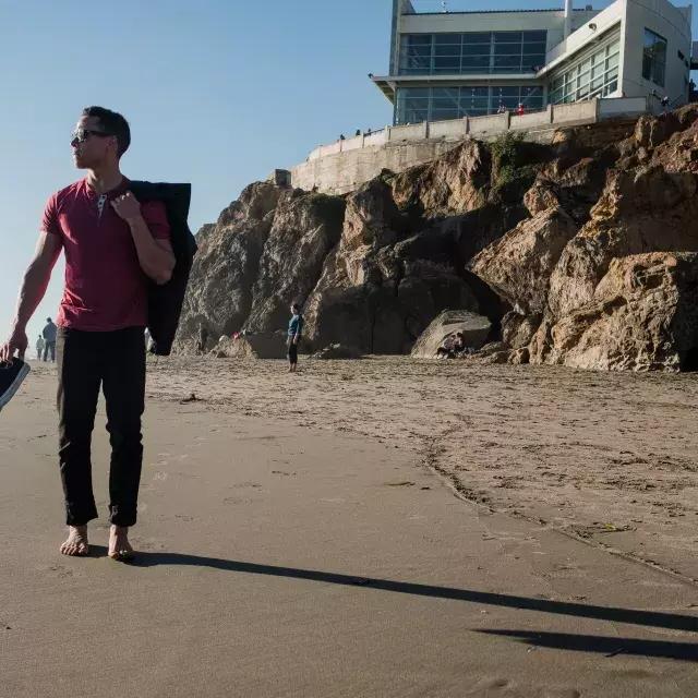 尼克·惠特莱斯在海洋海滩赤脚走路